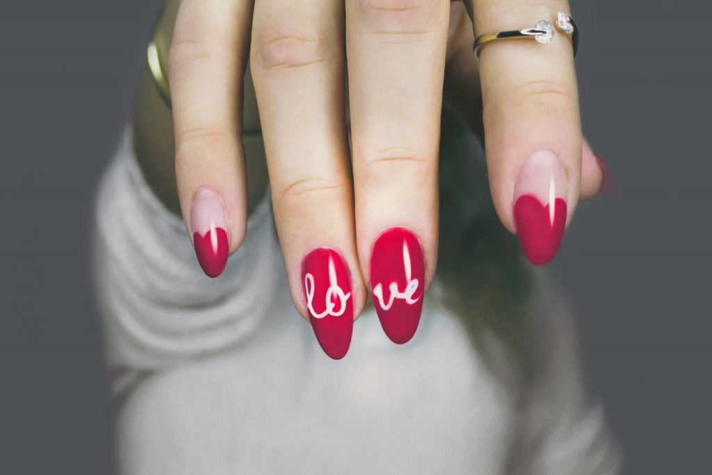 Dłoń z paznokciami pomalowanymi na czerwono